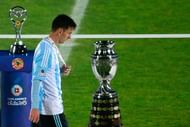 Lionel Messi walks past the Copa America trophy in 2015